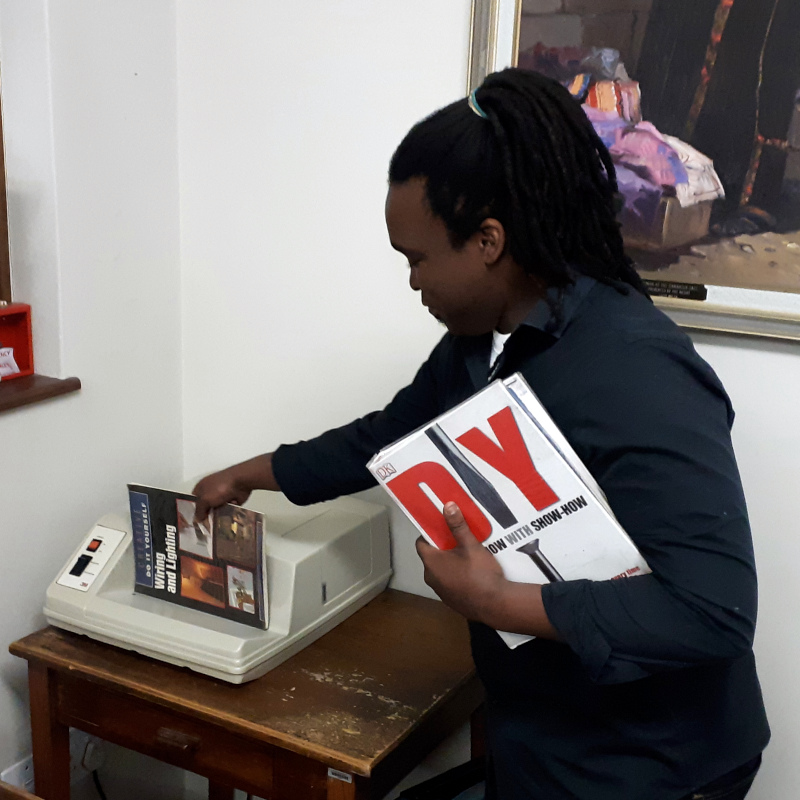A book being scanned out at the Knysna Library.